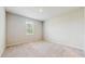Cozy bedroom with neutral carpeting, paint, and a large window providing ample natural light at 1824 Woodleaf Hammock Ct, Bradenton, FL 34211