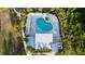 Aerial shot of a large community pool with lounge area and lush landscaping at 1824 Woodleaf Hammock Ct, Bradenton, FL 34211
