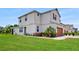 Beautiful side view of a two-story home with a large grassy lawn and well-maintained landscaping at 1824 Woodleaf Hammock Ct, Bradenton, FL 34211