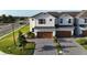 Charming two-story townhouse featuring a brick driveway and a two-car garage at 1824 Woodleaf Hammock Ct, Bradenton, FL 34211