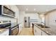 Modern kitchen with granite countertops, stainless steel appliances, and white cabinets at 1824 Woodleaf Hammock Ct, Bradenton, FL 34211