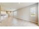 Open concept living room with neutral paint, large windows, and tile floors at 1824 Woodleaf Hammock Ct, Bradenton, FL 34211
