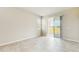 Bright, spacious room with tile floors and a sliding glass door leading to the backyard at 1824 Woodleaf Hammock Ct, Bradenton, FL 34211