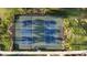 Aerial of well-maintained community tennis courts surrounded by lush landscaping at 1824 Woodleaf Hammock Ct, Bradenton, FL 34211