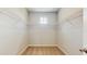 A well-organized walk-in closet with wire shelving and neutral carpeting at 1824 Woodleaf Hammock Ct, Bradenton, FL 34211