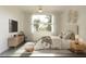 Serene bedroom featuring a plush bed, large window with natural light, and stylish decor at 18274 Grace Ave, Port Charlotte, FL 33948