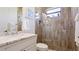 Beautiful bathroom with tiled shower, decorative pebbles, and white marble vanity provides an elegant and modern space at 20359 Cristoforo Pl, Venice, FL 34293