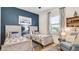 Cozy guest bedroom features twin beds, blue accent wall, and nautical-themed decor for a relaxing atmosphere at 20359 Cristoforo Pl, Venice, FL 34293