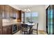 Cozy dining area with a wet bar, wine fridge, and tranquil views of the backyard pool at 20359 Cristoforo Pl, Venice, FL 34293