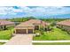 Stunning single-story home with a tile roof, three-car garage, and a lush, manicured lawn at 20359 Cristoforo Pl, Venice, FL 34293