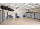 Spacious garage with epoxy flooring, lots of storage, and high ceilings provides ample room for vehicles and projects at 20359 Cristoforo Pl, Venice, FL 34293