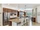 Modern kitchen with granite countertops, stainless steel appliances, and bar seating at 20359 Cristoforo Pl, Venice, FL 34293