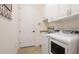 Clean laundry room boasts washer, dryer, wash basin, and white cabinets for optimal home convenience at 20359 Cristoforo Pl, Venice, FL 34293