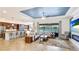 Open-concept living area featuring a tray ceiling, tile flooring, and expansive windows overlooking the lake at 20359 Cristoforo Pl, Venice, FL 34293