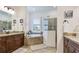 Luxurious bathroom with double vanity, soaking tub, and walk-in shower providing a relaxing space at 20359 Cristoforo Pl, Venice, FL 34293