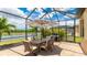 Outdoor dining area with a grill, table, chairs and a beautiful water view at 20359 Cristoforo Pl, Venice, FL 34293
