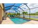 Relaxing pool with clear blue water, comfortable lounge chairs, and palm trees at 20359 Cristoforo Pl, Venice, FL 34293