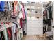Organized walk-in closet with built-in shelving, drawers, and hanging space for optimal storage at 20359 Cristoforo Pl, Venice, FL 34293