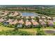 Lovely aerial view of homes with screened pools nestled beside a tranquil lake, surrounded by lush greenery at 207 Winding River Trl, Bradenton, FL 34212