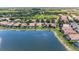 Beautiful aerial view of homes nestled beside a serene lake, offering picturesque waterfront living at 207 Winding River Trl, Bradenton, FL 34212