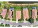 Overhead view of houses with pools and terracotta roofs in a neighborhood, showcasing a clean and well-kept community at 207 Winding River Trl, Bradenton, FL 34212