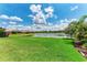 This expansive backyard provides scenic views of the lake at 207 Winding River Trl, Bradenton, FL 34212
