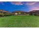 Expansive backyard featuring lush green grass and a covered patio, perfect for enjoying outdoor living at 207 Winding River Trl, Bradenton, FL 34212