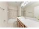 This bathroom features a large mirror, vanity and shower-tub combo at 207 Winding River Trl, Bradenton, FL 34212