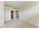 Carpeted bedroom features an attached walk-in closet with a view to another room at 207 Winding River Trl, Bradenton, FL 34212