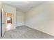 Bedroom with neutral carpeting, closet, and doorway to another room; plenty of space for personal touches at 207 Winding River Trl, Bradenton, FL 34212