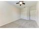 Bedroom featuring neutral carpet, ceiling fan, closet, and doorway to bathroom at 207 Winding River Trl, Bradenton, FL 34212