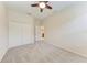 This bedroom features neutral walls, plush carpeting, and a ceiling fan at 207 Winding River Trl, Bradenton, FL 34212