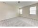 Expansive carpeted bedroom with multiple windows for abundant natural light at 207 Winding River Trl, Bradenton, FL 34212