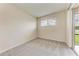 Neutral bedroom with carpet, a window, and a sliding door to the backyard at 207 Winding River Trl, Bradenton, FL 34212
