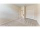 Bedroom featuring neutral carpet, closet, and doorway to bathroom offering lots of potential at 207 Winding River Trl, Bradenton, FL 34212