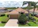 Charming home with a well-manicured lawn and a brick driveway, accented by lush landscaping at 207 Winding River Trl, Bradenton, FL 34212