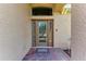 Elegant front door with decorative glass, sidelights, and brick paver entryway with a covered arch at 207 Winding River Trl, Bradenton, FL 34212