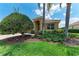 Beautiful front exterior with a brick driveway, landscaped yard, mature tree, and a single-car garage at 207 Winding River Trl, Bradenton, FL 34212