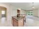 Kitchen features a center island, granite counters, and tile flooring at 207 Winding River Trl, Bradenton, FL 34212