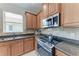 Kitchen boasts granite counters, tile backsplash, and stainless steel appliances at 207 Winding River Trl, Bradenton, FL 34212