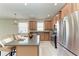 Bright kitchen features stainless steel appliances, a center island, and wood cabinetry at 207 Winding River Trl, Bradenton, FL 34212