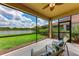 This screened-in lanai provides a peaceful spot to relax and enjoy scenic views at 207 Winding River Trl, Bradenton, FL 34212