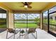 This screened-in lanai offers picturesque views of a serene lake and lush greenery at 207 Winding River Trl, Bradenton, FL 34212
