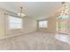 Bright living room with plush carpeting, neutral walls, and large windows for natural light at 207 Winding River Trl, Bradenton, FL 34212