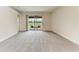 Spacious living room with screened-in porch access overlooking the water at 207 Winding River Trl, Bradenton, FL 34212
