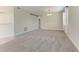 Bright, open living room featuring neutral carpet, white trim, and a modern chandelier at 207 Winding River Trl, Bradenton, FL 34212