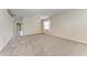 Spacious living room featuring neutral carpet, large windows, and an elegant light fixture at 207 Winding River Trl, Bradenton, FL 34212