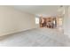 Open-concept living room with plush carpeting that leads to a modern kitchen at 207 Winding River Trl, Bradenton, FL 34212