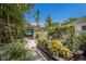 Backyard garden and stone pathway leading to a pool at 2207 Hickory Ave, Sarasota, FL 34234