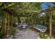 Backyard garden table with seating area under a wooden pergola at 2207 Hickory Ave, Sarasota, FL 34234